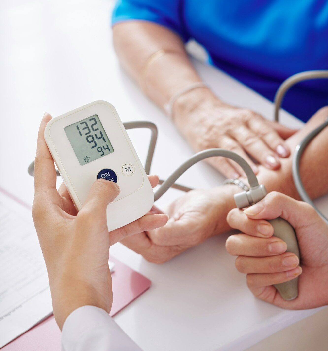 General practitioner checking blood pressure